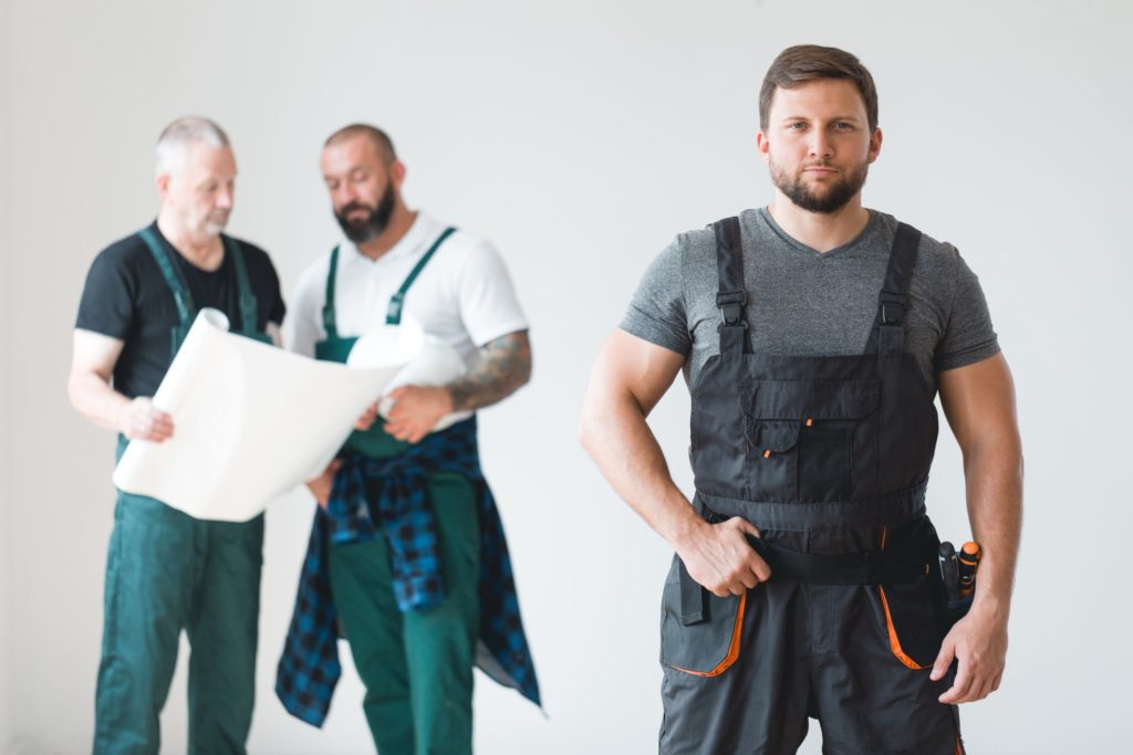 Group of three builders preparing for remodeling